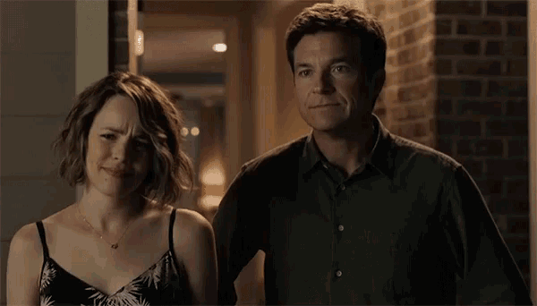 a man and a woman are standing next to each other and the man is saying " oh boy "