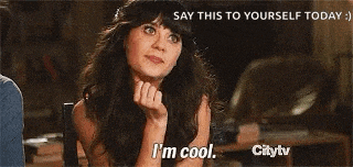 a woman is sitting in a chair with her hands up and saying `` i 'm cool '' .