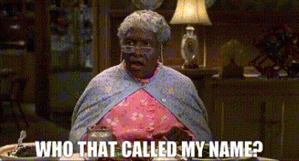 a woman is sitting at a table with a plate of food and a lamp and says `` who that called my name '' .