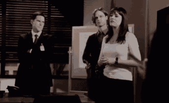a man and a woman are standing in a room .