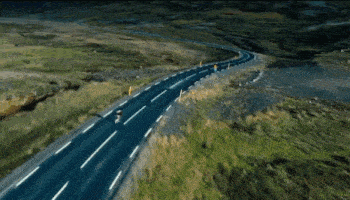 a man is riding a skateboard down a highway
