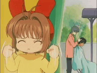 a girl with a red bow on her head is standing next to a man cutting another girl 's hair