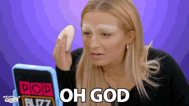 a woman is holding a sponge in front of a pop beauty buzz sign