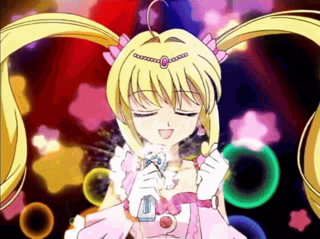 a girl in a pink dress is holding a microphone in her hand