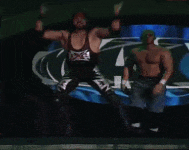 a wrestler in a black and white outfit with the letter x on it