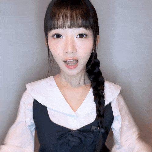 a girl with braided hair wearing a white shirt