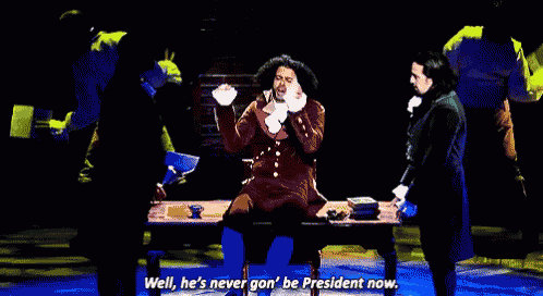 a man sitting at a desk with the words well he 's never gon ' be president now