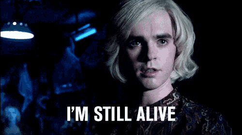 a man with blonde hair says i 'm still alive