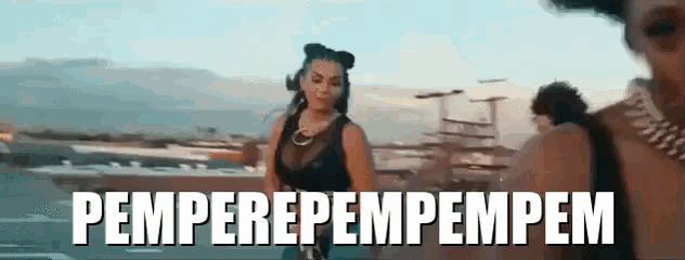 a woman in a black tank top is standing next to a man with the words pemperepempem written in white letters