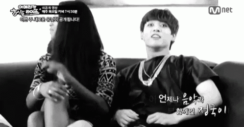 a man and a woman are sitting on a couch with mnet written in the corner