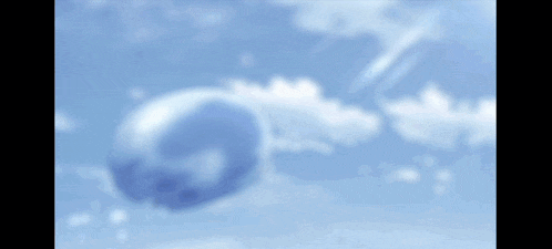 a blue balloon is floating in the air against a blue sky .