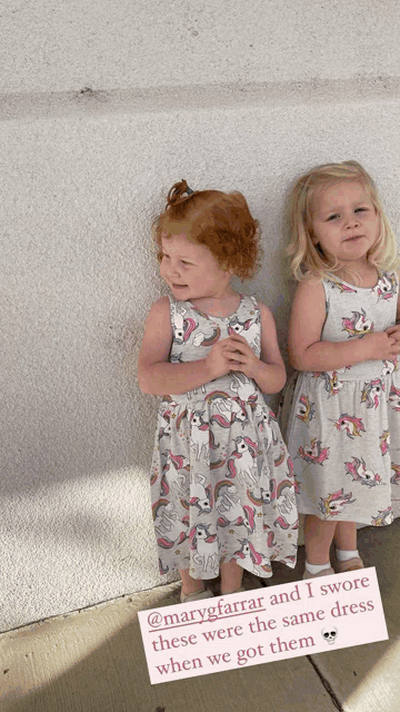 two little girls wearing dresses with unicorns on them