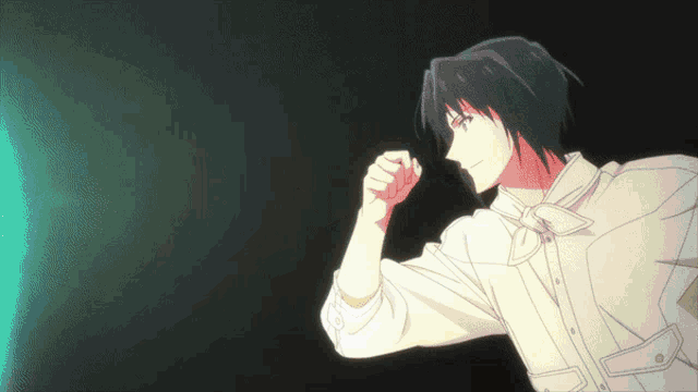 a man in a white shirt is flexing his arm in front of a green light