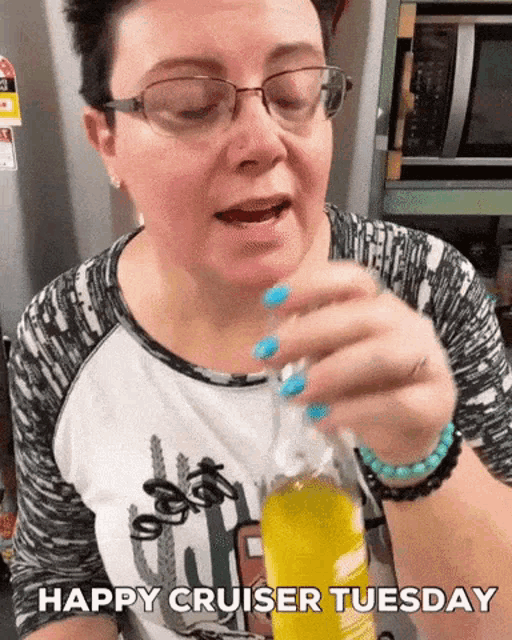 a woman holding a bottle with the words happy cruiser tuesday written on it