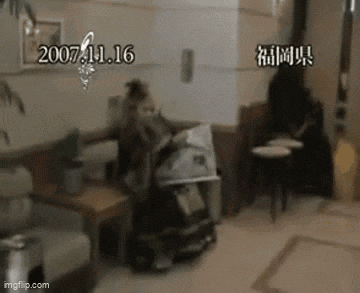 a monkey is sitting on a couch in a living room with a stroller .