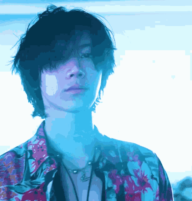 a close up of a person 's face with blue lights behind them