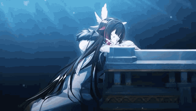 a girl with long black hair and white wings is sitting on a table