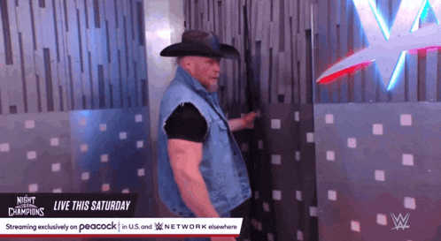 a man in a cowboy hat is standing in front of a wall that says night of the champions live this saturday