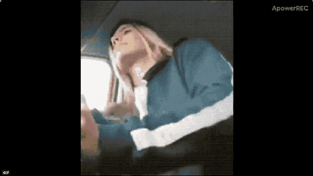 a woman is sitting in the back seat of a car looking up at the sky .