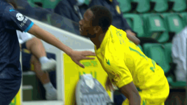 a soccer player wearing a yellow shirt with the number 1 on it