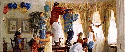a group of people are jumping in the air at a birthday party .