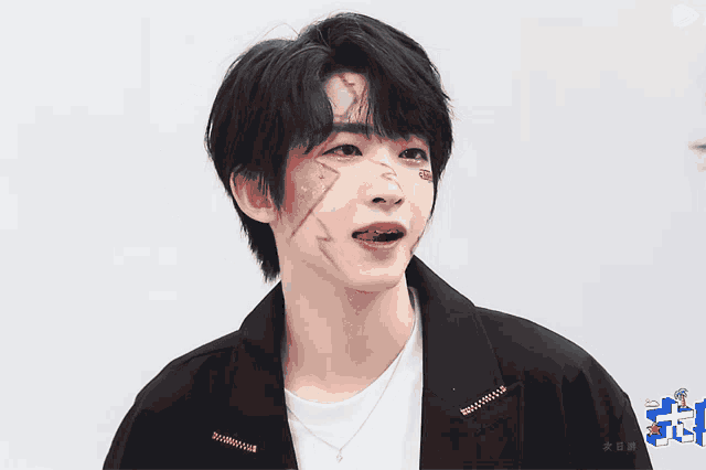 a young man with his tongue sticking out has a sticker on his face that says ' i love you '