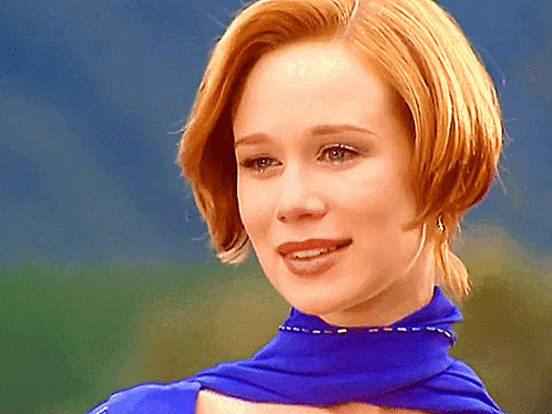 a close up of a woman wearing a blue scarf
