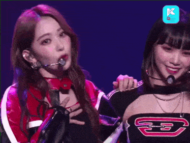 two girls are standing next to each other on a stage and one has a shirt that says e3 on it