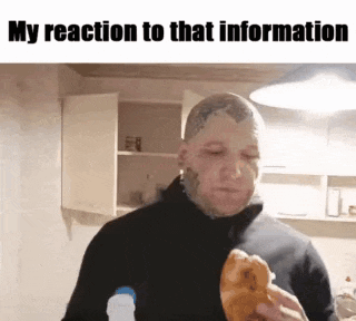 a man with a tattoo on his head is eating a croissant in a kitchen .