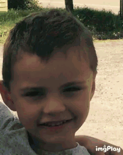 a close up of a child 's face with imgplay written on the bottom right