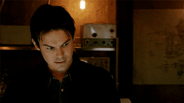 a man with a serious look on his face is looking at something