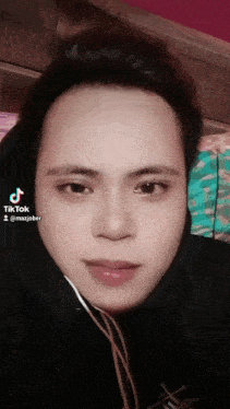 a close up of a man 's face with a tiktok sticker on it