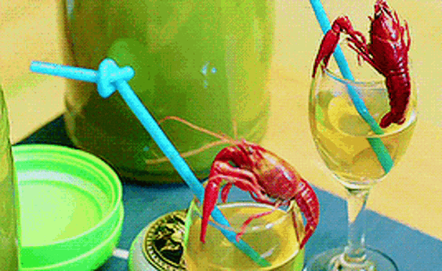 a crawfish is sticking out of a straw in a drink
