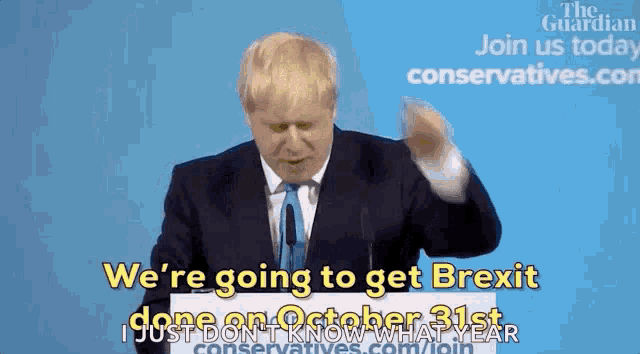 a man in a suit and tie is giving a speech and says we 're going to get brexit
