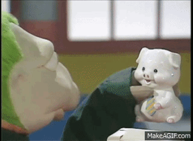 a person is holding a piggy bank in their hand