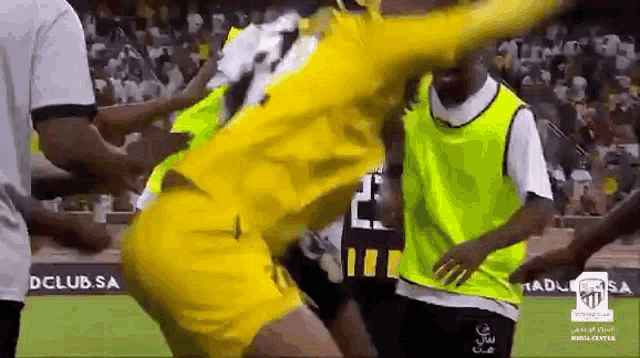 a man in a yellow jersey with the number 23 on it