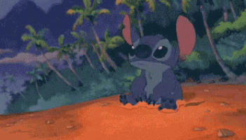 a pixel art drawing of stitch standing in a pile of sand