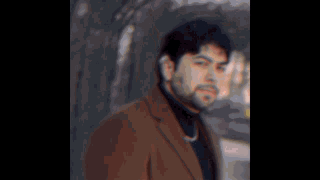 a close up of a man 's face with a blurred background