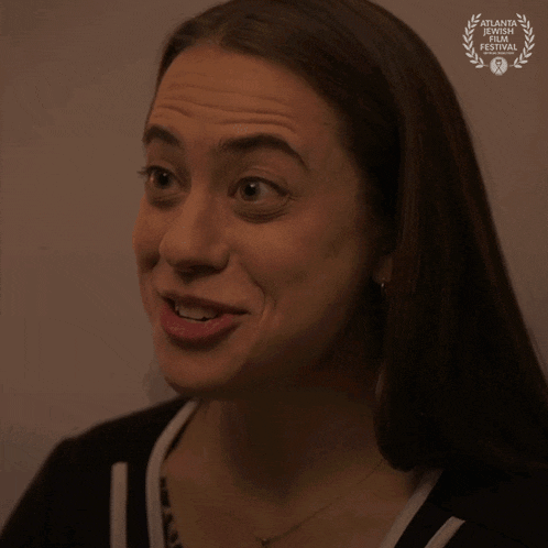 a close up of a woman 's face with the word shit written on it