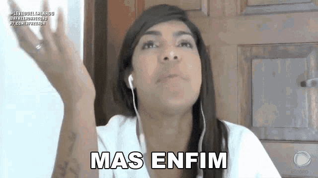 a woman wearing headphones says mas enfim in front of a wooden door .