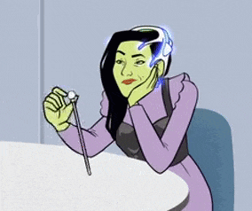 a woman with green hair is sitting at a table holding a sword .