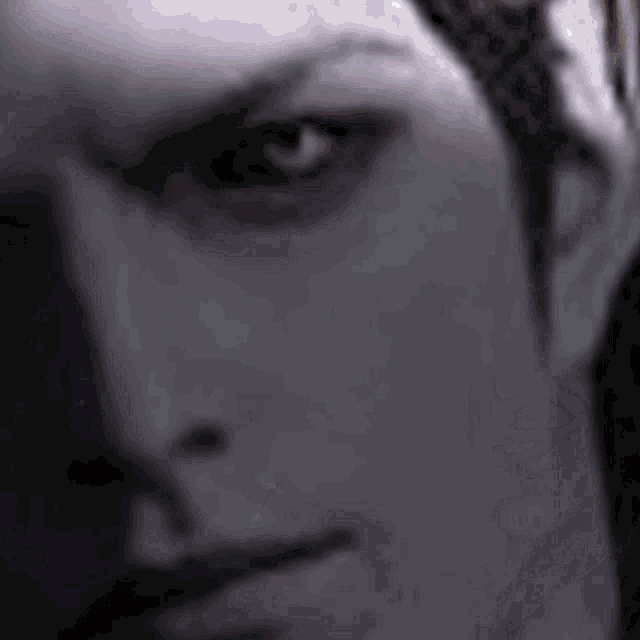 a close up of a man 's face with a blurred background