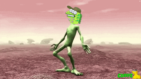 a green cartoon character with a hat on is dancing in a desert