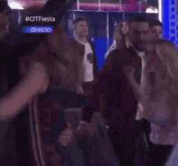 a group of people are dancing in front of a screen that says otfiesta