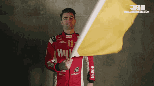 a man in a red and white uniform holds a yellow flag in front of a sign that says royal letterman law