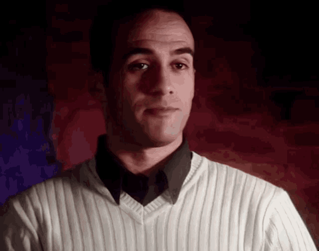 a man wearing a striped sweater and a black tie