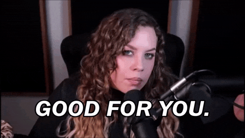 a woman is sitting in front of a microphone with the words `` good for you '' written on the screen .