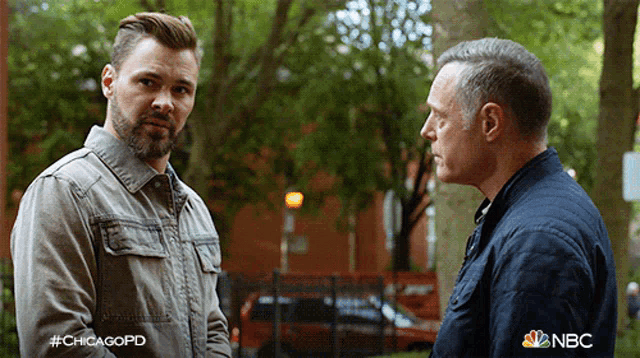 two men standing next to each other with a nbc logo on the bottom