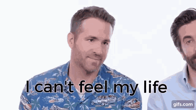 two men are standing next to each other and one of them is saying i can 't feel my life .