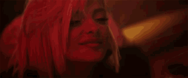 a close up of a woman 's face in red light